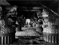 Stone carver standing among unfinished corinthian capitals