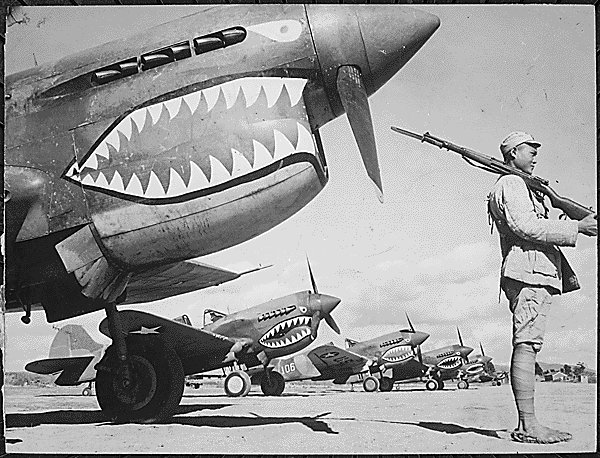 A Chinese soldier guards a line of American P-40 fighter planes...