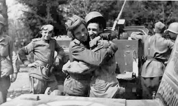 American and Russian soldiers embrace on the banks of  the Elbe River, April 25, 1945 