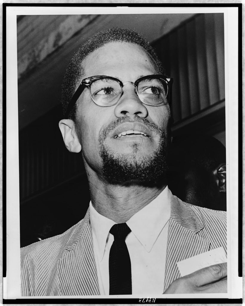 Malcolm X, head-and-shoulders portrait, facing right.