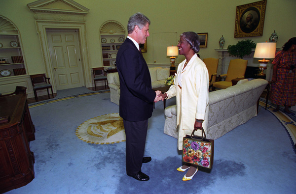 Shirley Chisholm and Bill Clinton shaking hands