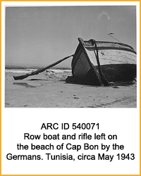National Archives Identifier 540071 Row boat and rifle left on the beach of Cap Bon by the Germans. Tunisia, circa May 1943., 1943 - 1944