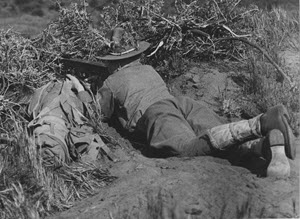Soldier of the 63rd. Regt. Inf. camouflaged and dug in a concealed rifle pit with his rapid fire new model French Chauchat rifle