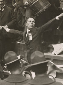 Charlie Chaplin, movie star, leading the band at the Public Library, New York City, to spread the "Buy Liberty Bonds" slogan