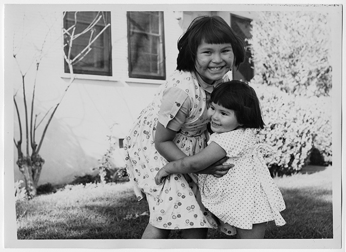 Two young Navajo girls embracing 