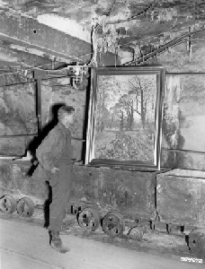 Corporal Dolald Ornitz examines painting in underground vault