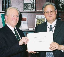Lee Gladwin presents Michael Kurtz with a copy of the Bletchley Park visitors' book