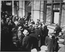 Anxious depositors in Cleveland, Ohio, learn that withdrawals are limited to five percent of their deposits, February 28, 1933