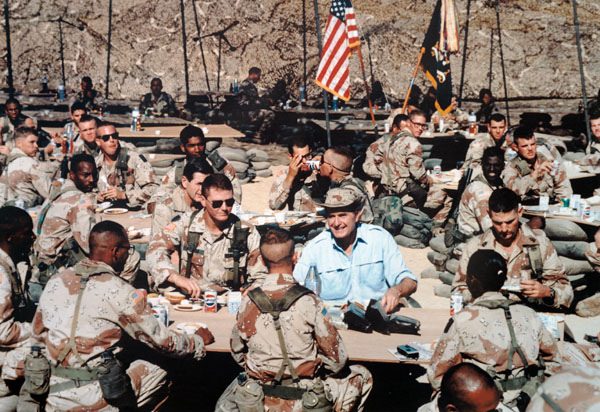 "President George Bush enjoys Thanksgiving Dinner with U.S. troops stationed in the Persian Gulf"