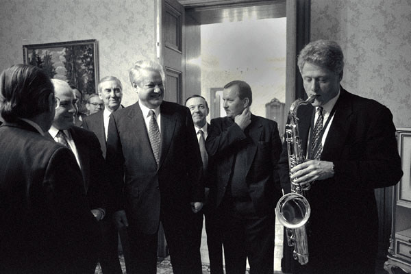 "Presiden Bill Clinton plays the saxophone presented to him by Russian President Boris Yeltsin..."
