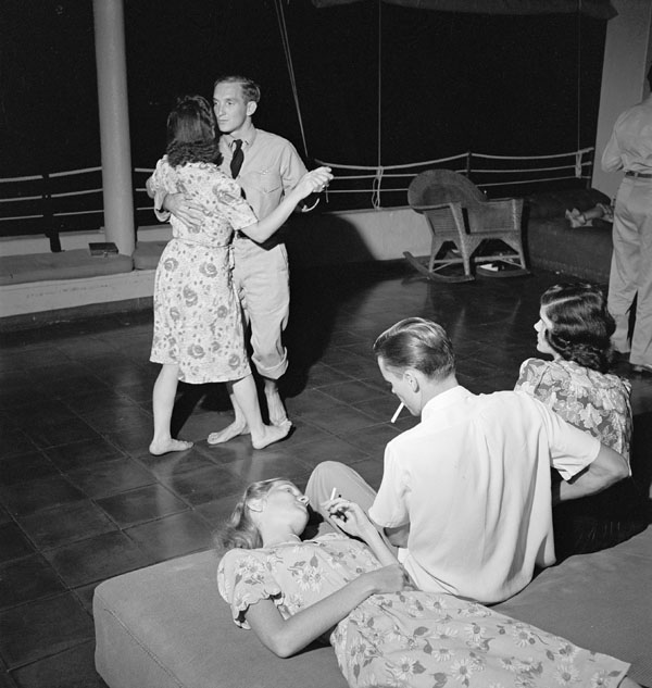 "Navy pilots on leave dancing with their dates at the Chris Holmes Rest Home in Hawaii."