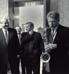 Presiden Bill Clinton plays the saxophone presented to him by Russian Presiden Boris Yeltsin