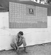 Tired member of VF-17 pauses under the squadron scoreboard at Bougainville