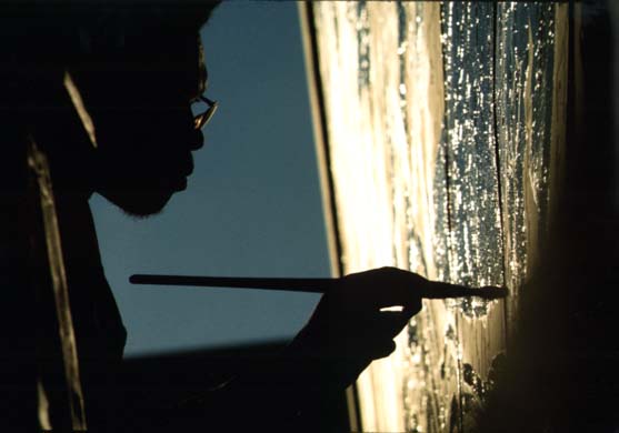Artist Ron Blackburn painting an outdoor wall mural at the corner of 33rd and Giles Streets in Chicago. October 1973 (NWDNS-412-DA-13776)