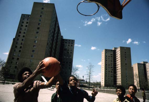 Black youths play basketball at Stateway Gardens' high-rise housing project on Chicago's South Side. May 1973 (NWDNS-412-DA-13710)