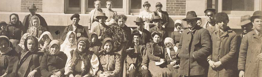 Photograph of a Group of Immigrants Outside a Building on Ellis Island