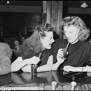Ella Jane Fain (right) daughter of Harry Fain, miner, and her cousin have a coke in soda fountain prior to movie showing. Inland Steel Company, Wheelwright #1 & 2 Mines. Wheelwright, Floyd County, Kentucky.