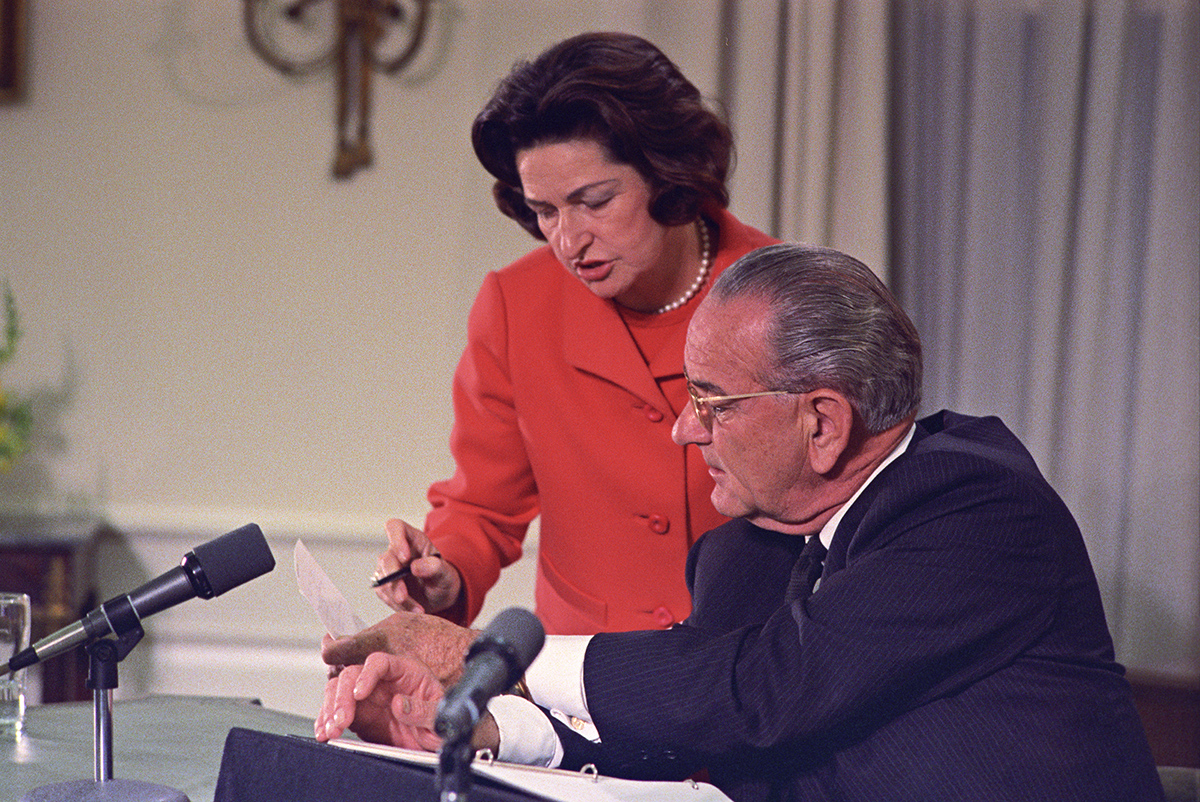 Lady Bird and Lyndon Johnson at a desk