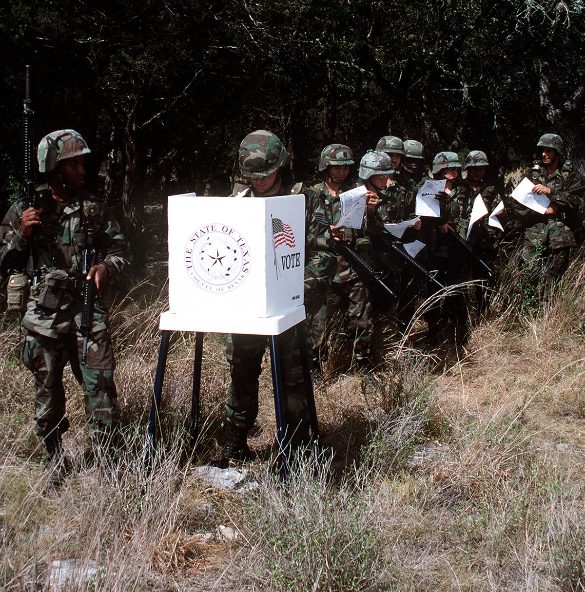 Members of the United States Air Force with their ballots in hand, are ready to exercise their freedom to vote under field conditions.