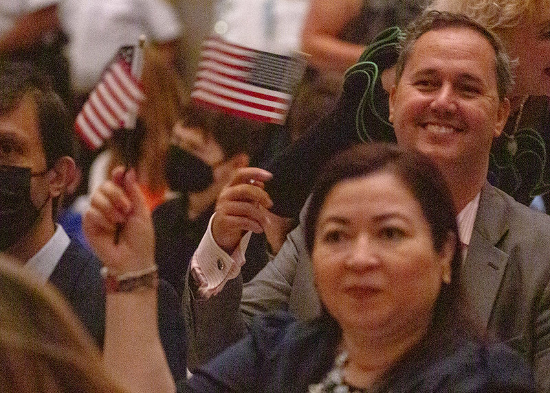 Candidates for naturalization wave American flags in the Rotunda of the National Archives and Records Administration (NARA). Washington, DC, September 14, 2022. NARA photo by Susana Raab.