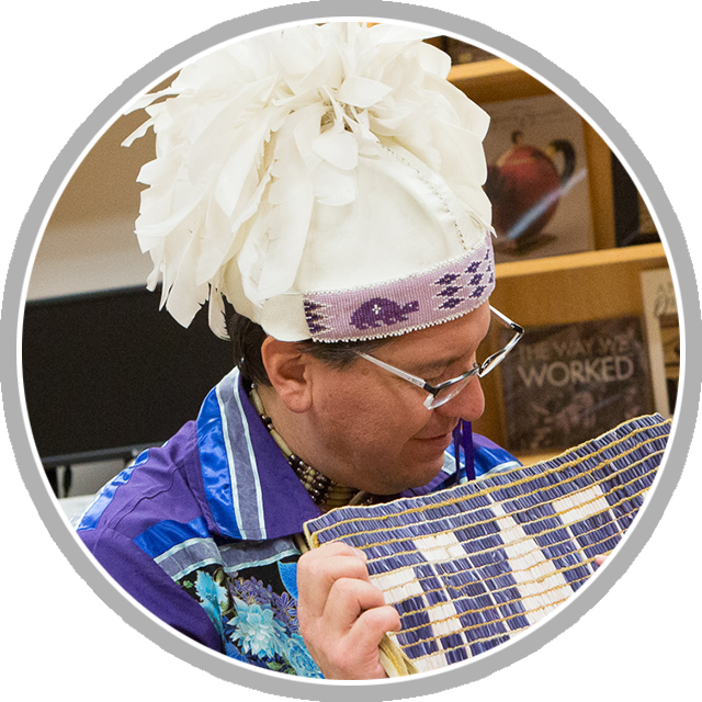 Perry Gordon tells a visitor about wampum