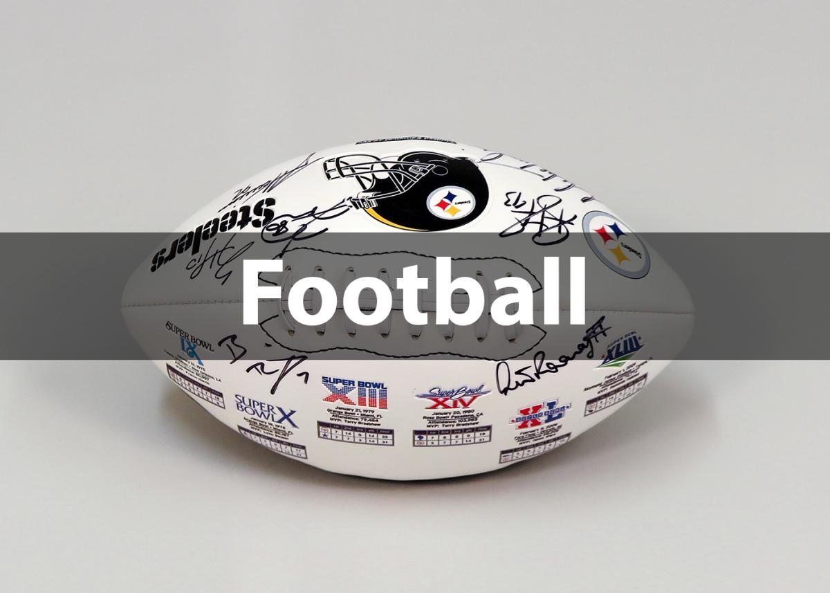 Close up image of a white football with the Steelers logo and many signatures