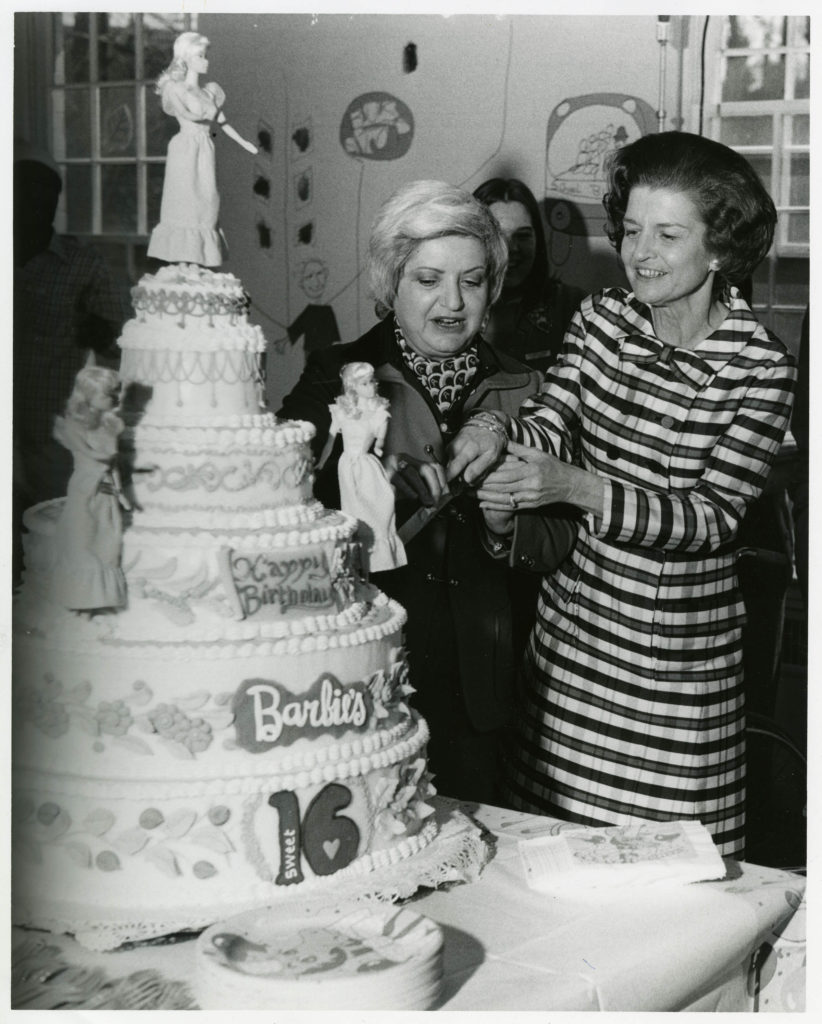Betty Ford cuts a cake for the Barbie Doll's 16th birthday