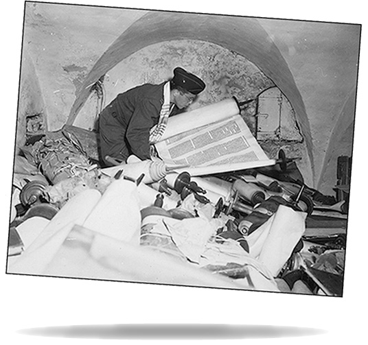 Chaplain Samuel Blinder examines one of hundreds of "Saphor Torahs" among the books stolen from every occupied country in Europe.