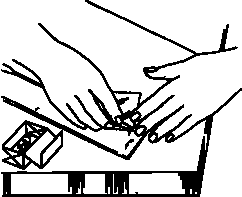 Hands removing staple from a document.