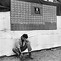 Tired member of VF-17 pauses under the squadron scoreboard at Bouganville