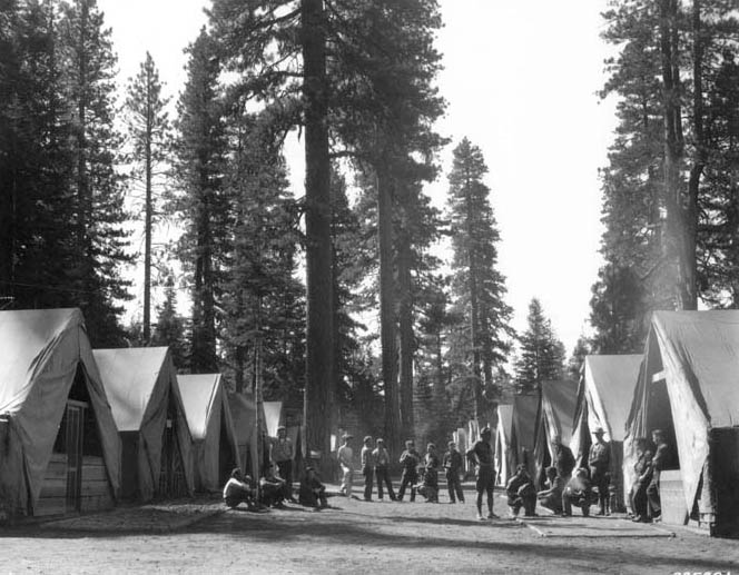 Men stand in front of their tents at Breen Burney Camp in Lassen National Forest, California