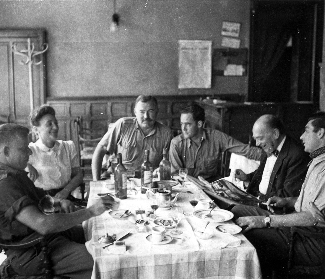 At Mere Poulard restaurant in Paris 1944: Bill Walton, Mme. Chevalier, Ernest Hemingway, an unidentified Signal Corps photographer, M. Chevalier, and Robert Capa