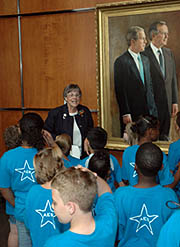 A volunteer at the Bush Library talks to a group of school children 