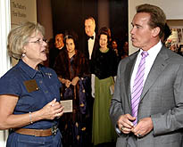 A volunteer gives California Governor Arnold Schwarzenegger a tour of the Johnson Library