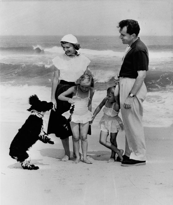 Richard and Pat Nixon on the beach with daughters Tricia and Julie and dog Checkers