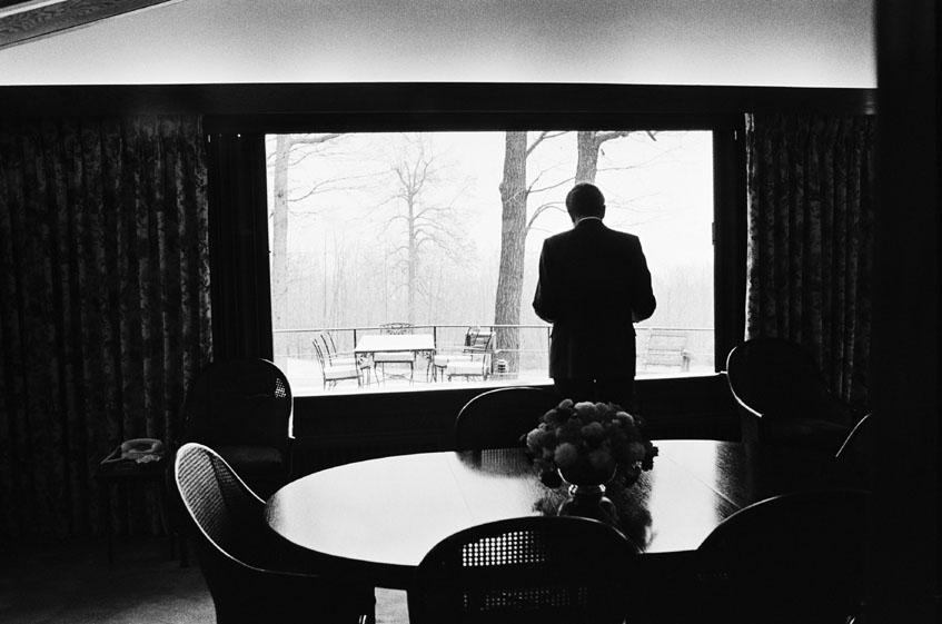 President Nixon looks out at the falling snow at Camp David, November 22, 1972