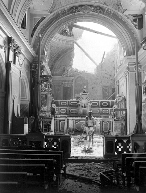 Pvt. Paul Oglesby, 30th Infantry, examines the damage to the altar of a Catholic church in Acerno, Italy