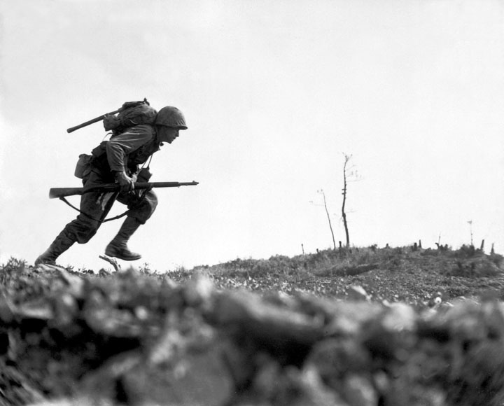 On Okinawa, a marine dashes across a field called  Death Valley
