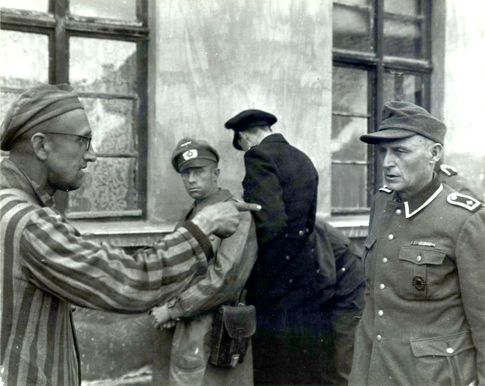 After liberation, a Russian slave laborer points out a former Nazi guard who brutally beat prisoners