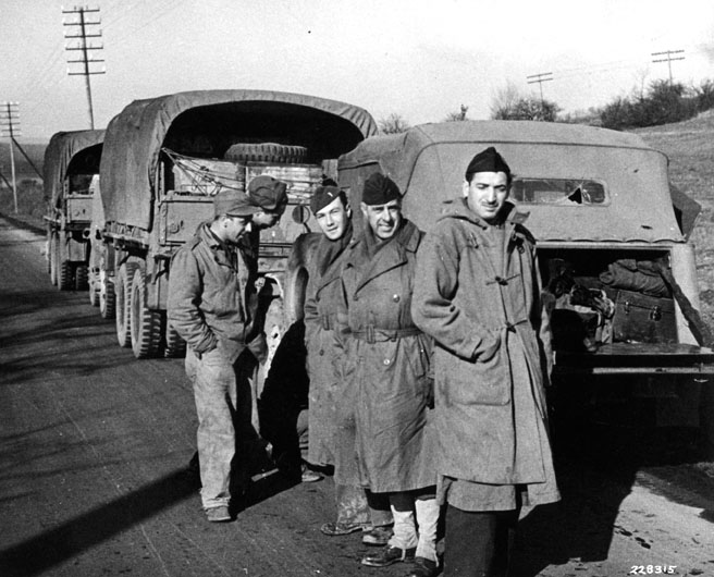 Pvt. Carmine Catusco, Pvt. John Ecker, French Army 1st Lt. Leo Silberbauer, journalist Lionel Shapiro, and French Army Sgt. Antoine Vital at a stop on the return trip to Germany