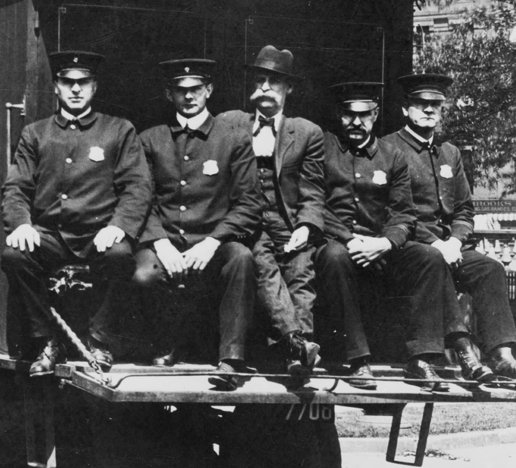 DC Metropolitan Police sit at the back of a police wagon