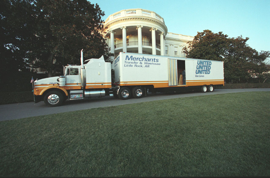 Photo of the White House with a moving van parked in front
