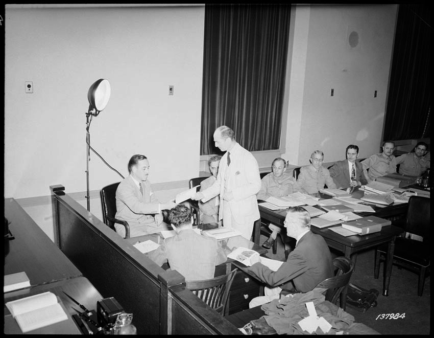 Attorney General Nicholas Biddle questions FBI agent Lenman at the trial of Nazi saboteurs on July 9, 1942