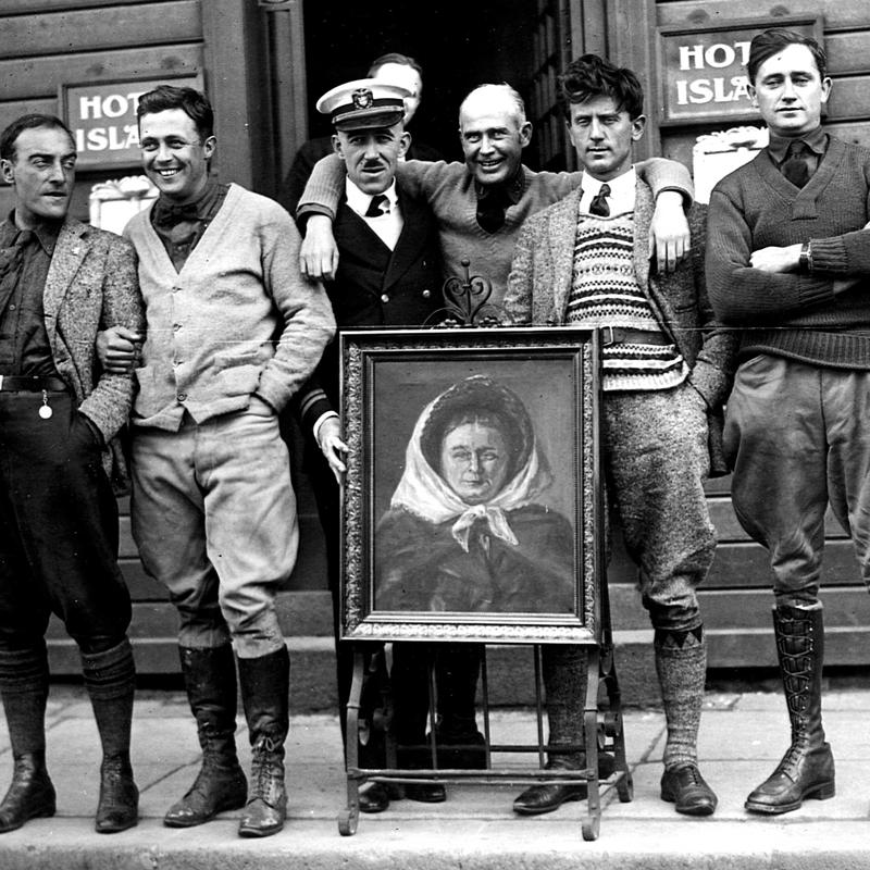 F. C. Crosio (Italian flier), 1st Lt. John Harding, Dr. Summer of the USS Richmond, 1st Lt. Erik Nelson, Antonio Locatelli (Italian pilot), and 1st Lt. Lowell Smith in Reykjavik, Iceland, pose with a painting of the  Belle of Iceland. 