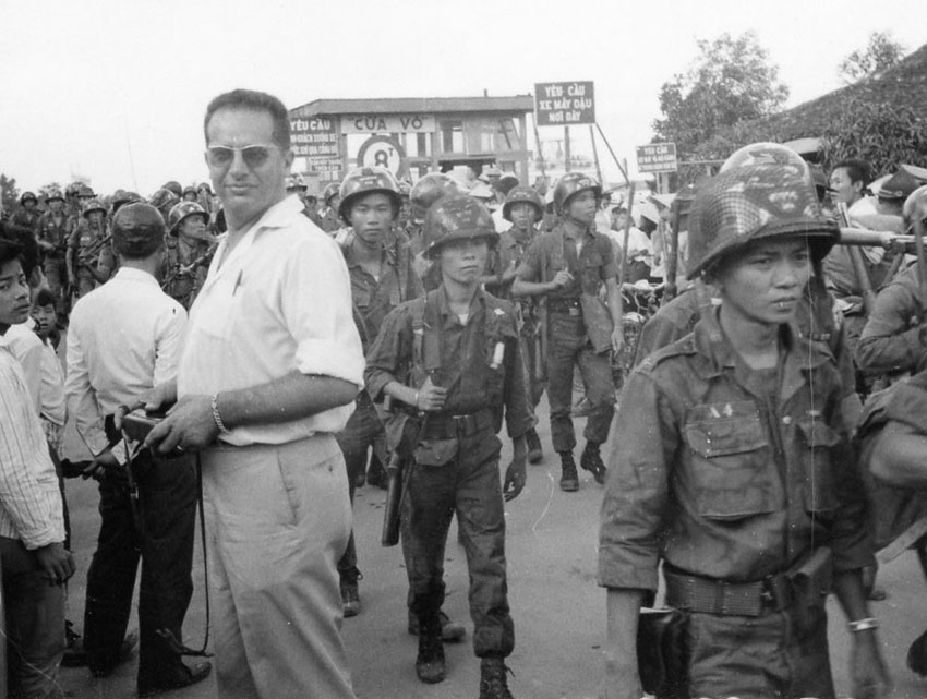 Bernard Fall on a Vietnam street with soldiers, undated. 