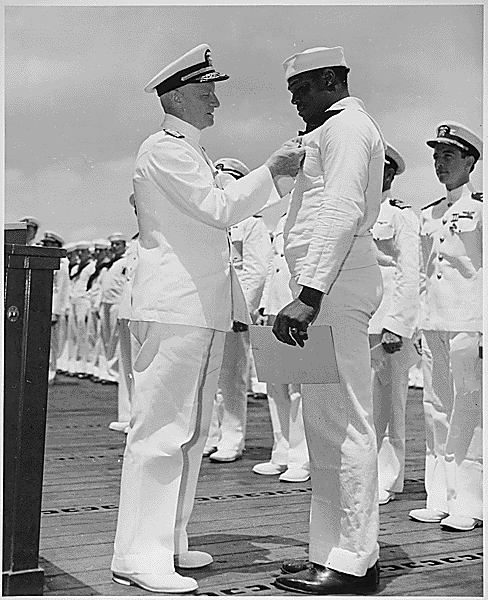 Admiral Chester W. Nimitz pins the Navy Cross on Doris Miller at a ceremony in Pearl Harbor, May 27, 1942