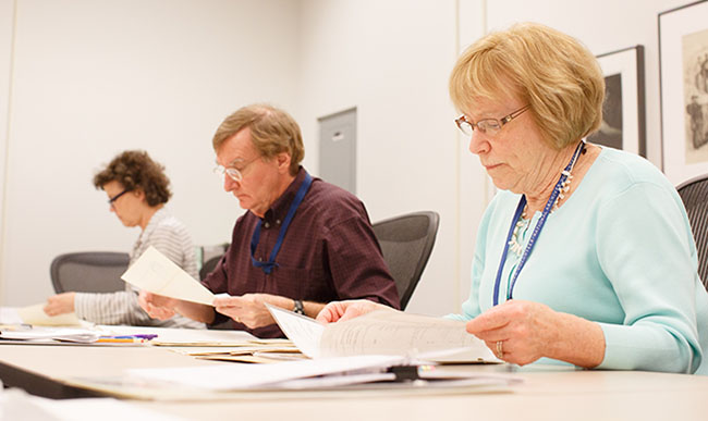 Volunteers examine Civil War records