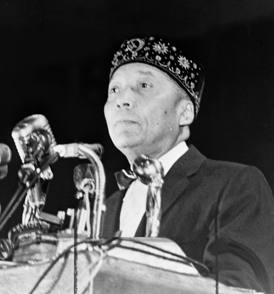 Muhammad speaking at a podium