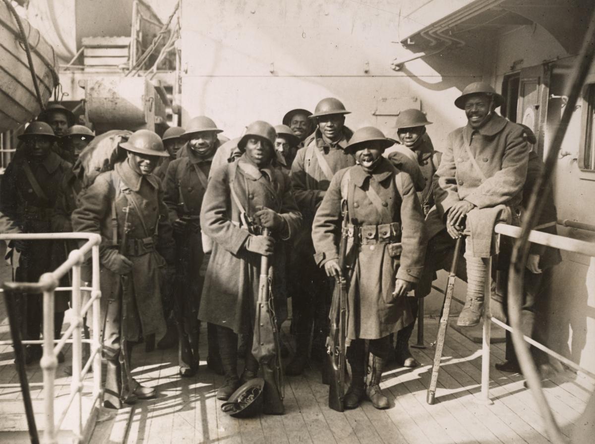soldiers on board the France facing and smiling at camera