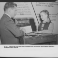 An FBI agent taking the one hundred millionth fingerprint, represented by Margaret O'Brien, a movie star
